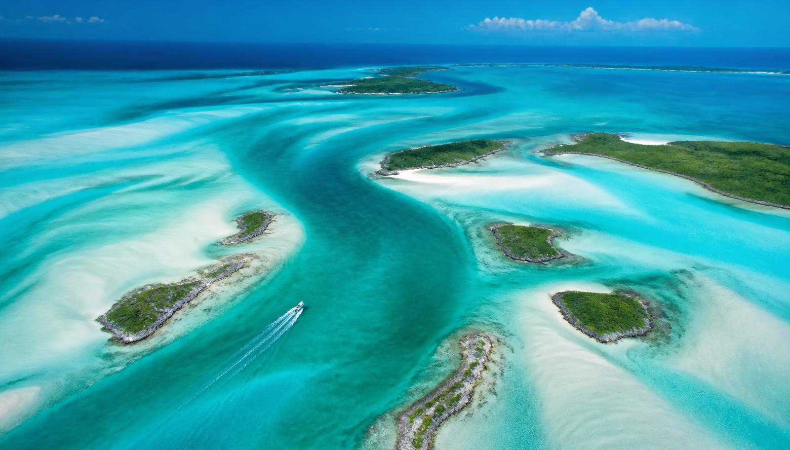 Aerial view of the Exuma Cays in the Bahamas — turquoise shallows, white sandbanks and small green cays